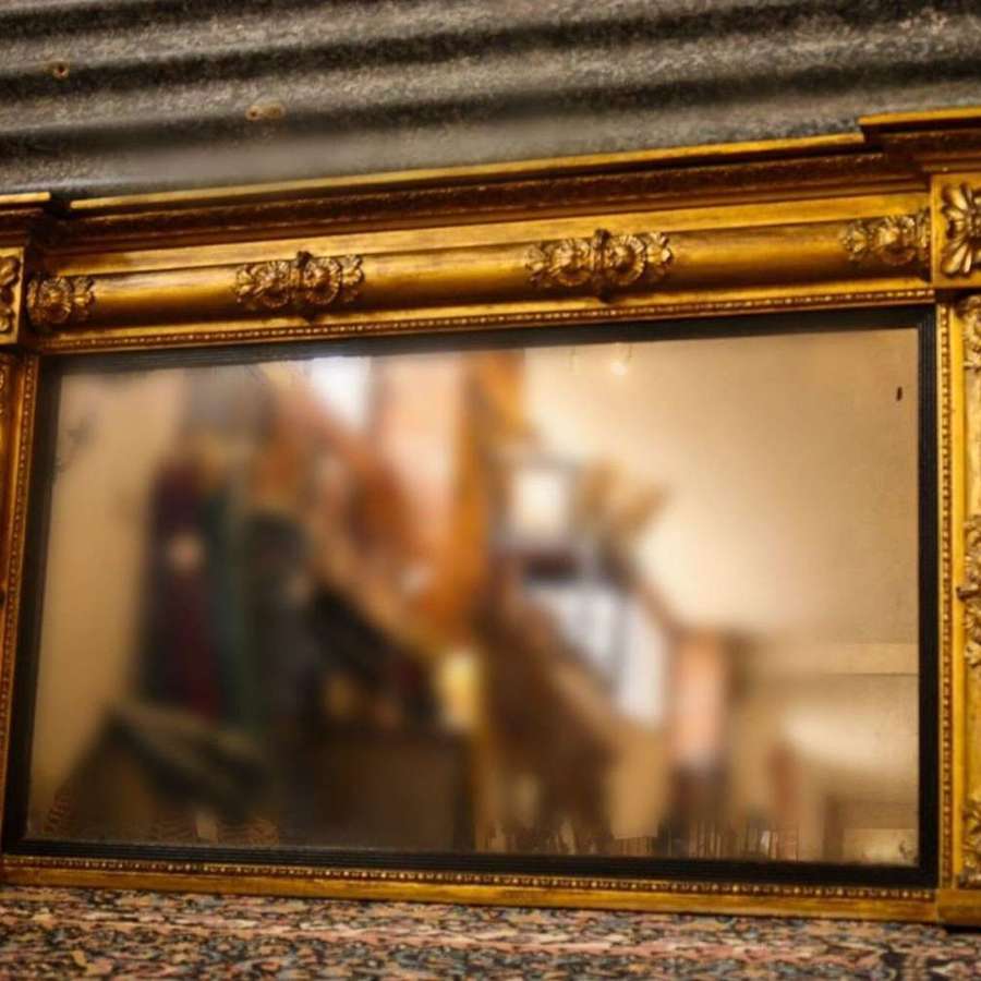 A Regency inverted breakfront giltwood overmantle mirror